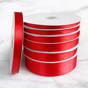 Detailed set of red satin ribbons in various widths for gift wrapping and decoration