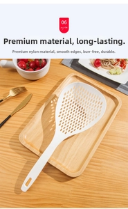Macro detail of a white heat-resistant nylon slotted spoon on a wooden kitchen tray