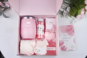 Detail of pink spa gift set including tumbler, bath salt, candle, and towel