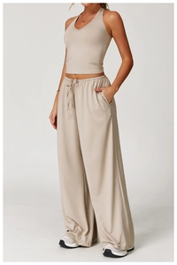 Detail of high-waisted wide-leg trousers with drawstring waistband and side pockets