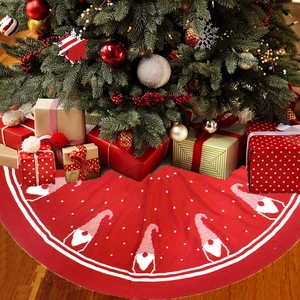 Red knitted Christmas tree skirt featuring white gnome patterns and polka dots