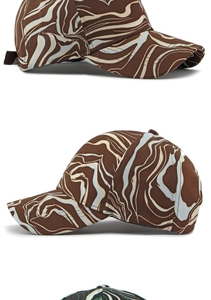 Detail view of the side profile showing brown and beige marble fluid print baseball cap