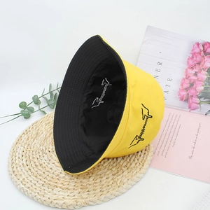 Fashionable reversible cotton bucket hat in yellow and black with 'something' embroidery