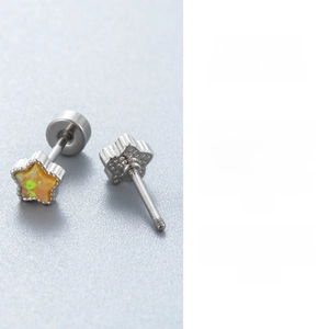 Close-up of star-shaped titanium steel ear studs with orange opal inlay and screw back
