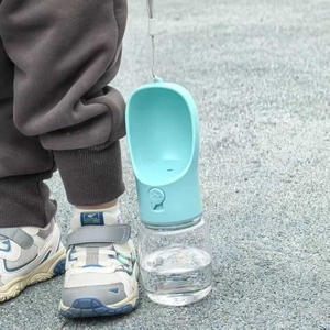 Portable pet water bottle in light blue with hanging strap for outdoor dog travel