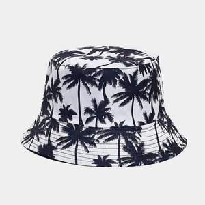 Close-up of tropical palm tree print and reinforced stitching on white bucket hat