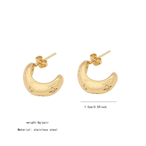 Detail view of 1.5cm gold C-shaped stainless steel earrings with star-set cubic zirconia