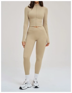 Detail of khaki yoga set showing the zipper jacket and cross V-waist leggings
