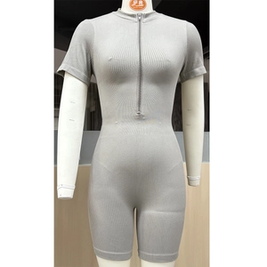 Detail shot of grey ribbed seamless fitness jumpsuit with a half-zip neckline