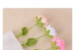 Detailed view of handmade crochet roses in pink and white with LOVE packaging bags