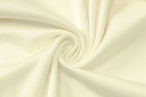 Close-up of the ivory white knitted fabric showing detailed texture and drape of the bodysuit