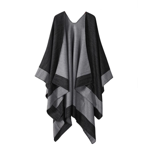 Detail of dark grey double-sided knitted shawl featuring light grey stripes and soft texture