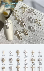 Macro shot of 3D alloy cross nail charms with rhinestones in various sizes and models