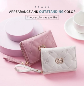 Short quilted zip wallet with floral embroidery and wrist strap in pink and grey