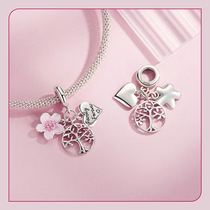 Macro shot of S925 sterling silver Tree of Life and heart charms with Family Forever engraving