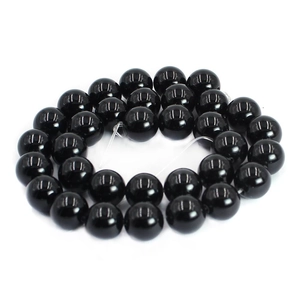 Close-up of polished black agate round beads with glossy finish for DIY jewelry