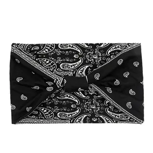 Close-up of black elastic paisley sports headband with twisted knot design details