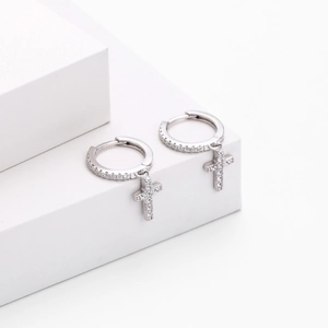 Detailed macro view of S925 sterling silver hallmark on cross hoop earrings with zircons