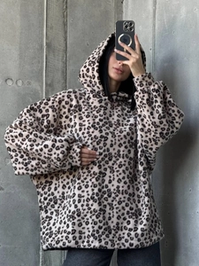 Close-up of leopard print oversized fleece hoodie with ribbed cuffs and soft texture