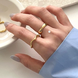 Detail of 925 sterling silver gold plated chunky irregular and twisted rope open rings