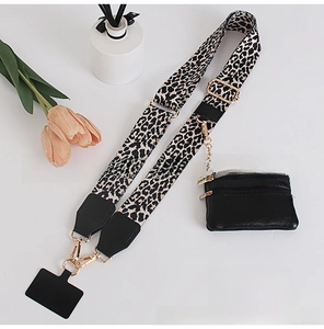 Close-up of leopard print phone strap with black leather pouch and gold metal hardware