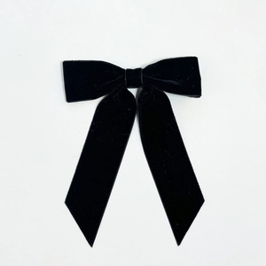 French vintage black velvet bow hair clip with long ribbons on white background