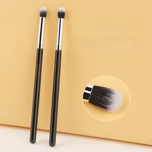 Detailed view of dual-ended eyeshadow brush with soft fiber bristles and wood handle