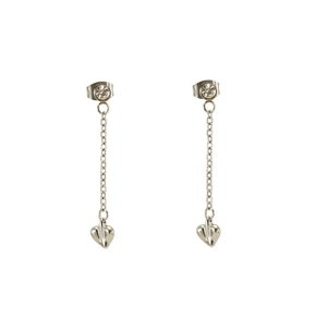 Macro detail of silver tassel earrings featuring sparkling rhinestones and heart pendants