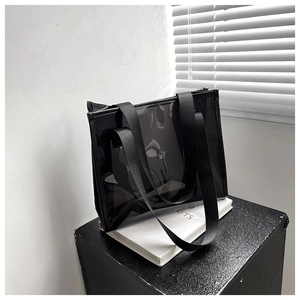 Detailed view of the large capacity black transparent PVC tote bag with nylon handles