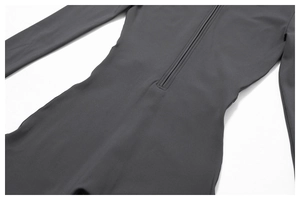 Detailed macro view of the front zipper and neckline of the thermal yoga bodysuit