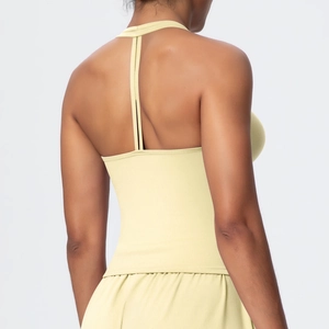 Detail of cross-strap back design on a yellow brushed yoga sports bra for workout