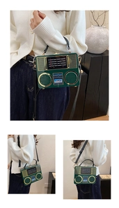 Detailed macro view of dark green retro radio-style acrylic box bag with gold metal trim