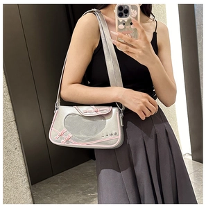 Close-up of silver Y2K bag with heart-shaped mesh window and pink bow details