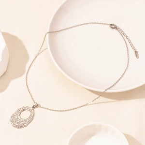 Detail of silver stainless steel necklace with textured hollow oval pendant and lobster clasp