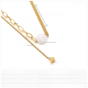 Detail of gold titanium steel mixed link necklace with white shell disk pendant