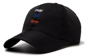 Detail of black quick-dry baseball cap featuring mesh side vents and three-color embroidery