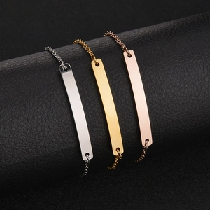 Detailed macro view of minimalist titanium steel bar bracelets in silver, gold, and rose gold