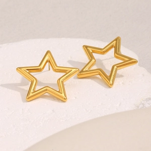 Detailed view of hollow star-shaped 18K gold-plated stainless steel stud earrings on stone