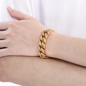 Close-up of golden 15mm chunky Cuban link bracelet with frosted dotted texture on wrist