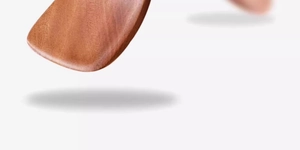 Macro detail showing rich wood grain and smooth finish of a long-handle ebony spatula