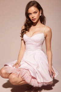 Detail of pink satin mini dress featuring layered mesh hem and delicate spaghetti straps