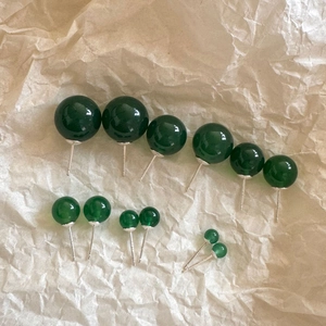 Minimalist green agate silver stud earrings in various sizes on neutral paper background