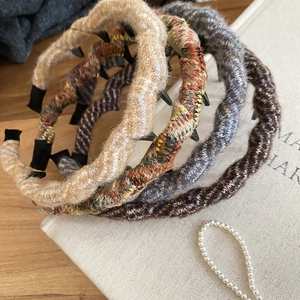 Detailed texture of wavy knitted acrylic wool headbands in various autumn colors
