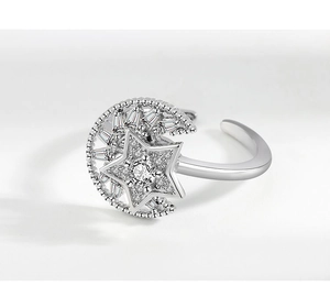 Detailed close-up of rotating moon and star adjustable ring with crystal inlay