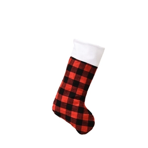 Classic red and black buffalo plaid Christmas stocking with white plush cuff for decor