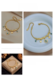 Detail of gold celestial snake chain bracelet with star and turquoise sun pendants