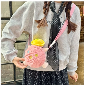 Detail of pink plush crossbody bag with star embroidery and cute yellow hat on model