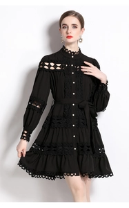 Detailed view of hollow lace embroidery and white pearl buttons on a black palace dress