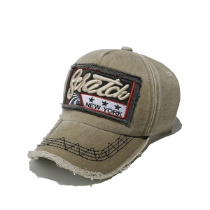 Detail of khaki distressed baseball cap featuring Scratch New York embroidery and frayed brim