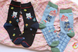 Close-up of animal embroidery featuring cats and rabbits on colorful cotton socks